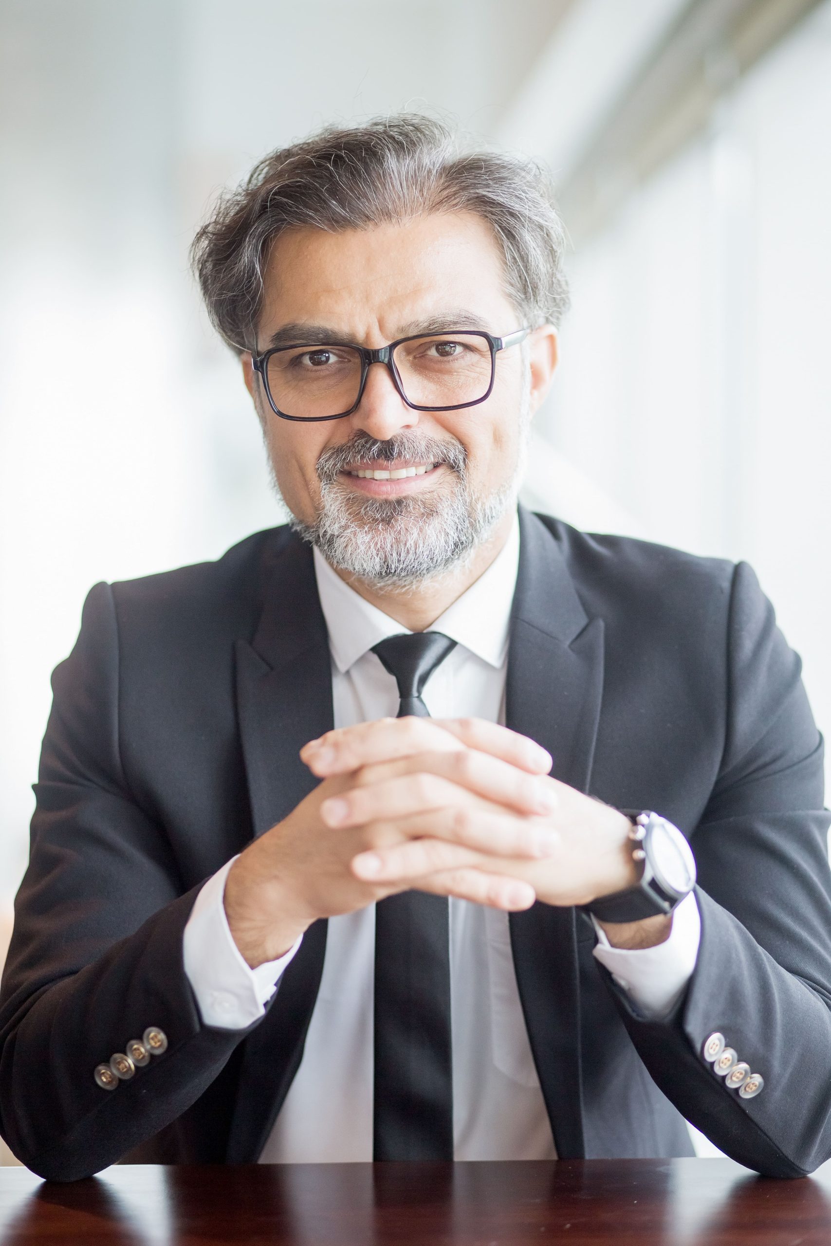 closeup smiling business leader sitting table (1)